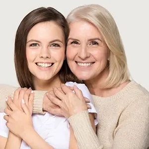 A mom and daughter smiling